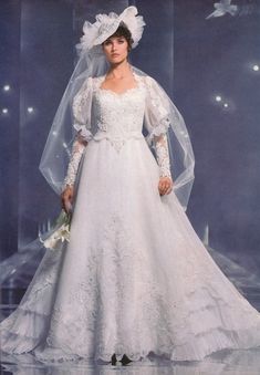 a woman in a white wedding dress and veil