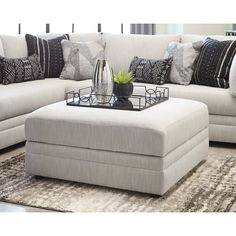 a living room scene with focus on the ottoman