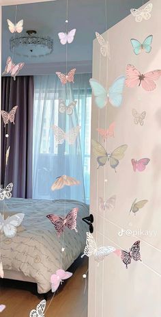 a bedroom with butterflies hanging from the ceiling