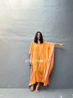 Legian Kaftan Take it easy this season in a simple & relaxed Kaftan that's just as effortless as it is chic. Made with lightweight and breathable rayon voile, loose & easy fit with an eye catching color blocking, this kaftan dress is perfect for every occasion - dressed up or down. * Color -  Tie dye - orange &   motif  * Size  One size  American size From S to L *Total width  /220cm/86inch (round)  Chest & him /150cm/59inch(round)  The length /130cm/51inch * Stylepark1 Model  * Her height is 17 Casual V-neck Kurta For Summer, Spring Casual Long Kurta, Casual Long Kurta For Spring, Casual Orange Kurta For Summer, Yellow Long Casual Kaftan, Casual Long Yellow Kaftan, Casual Orange Kaftan For Summer, Long Sleeve Orange Kurta For Summer, Orange Long Sleeve Kurta For Summer