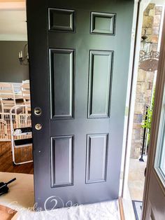 the front door is painted dark green