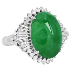 A halo of diamonds surrounds by A Natural Apple Green Jade.  This jade cocktail ring is crafted in solid Platinum,  featuring in the center a Cabochon Oval Cut GIA Green Jade of approx. 9.58 carats, natural color without any treatments. The center stone measures appx. 17.80x 12.63 x 5.65 mm. Surrounding the jade are natural Baguettes and round diamonds, weighing approximately. 1.44 carats  G-H color and VS1 clarity. Purity Stamped. Currently, a US size is 7.75 and is sizable. Remains in Excellent Condition. Accompanied by a GIA # 2221886113 Report and a Professional Appraisal Document. Vintage Platinum Rings, Cabochon Ring, Platinum Ring, Apple Green, Green Jade, Halo Rings, Jade Green, Oval Cabochon, Vintage Diamond