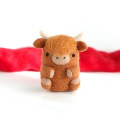 a small brown cow sitting on top of a white table