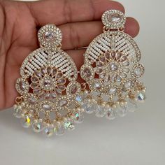 Celebration Pearl Drop Chandbalis, White Chandbali Chandelier Earrings For Party, White Chandelier Earrings With Stone Work For Celebrations, Heavy White Chandbalis For Party, White Heavy Chandbalis For Party, Party Chandbali Chandelier Earrings With Pearl Drop, Bollywood Style Pearl Earrings With Stone Work For Celebration, White Bollywood Chandelier Earrings With Intricate Design, Bollywood Style White Chandelier Earrings With Intricate Design