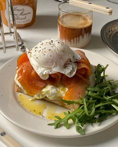 a white plate topped with an open face sandwich