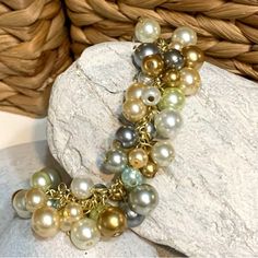 Multicolored High Grade Faux And Seashell Pearls In Subdued Shades Of Smoke, Silver, Copper, Shell Pink, Sea Foam And White And Drip In Clusters From A Linked Bracelet. The Light Gold Tone Bracelet Adds A Soft Glow Without Really Adding Another Color To The Mix. So Versatile You Can Wear For Evening Events, Weddings, Or Wear With Jeans And A Fresh Spring White Top For A Super Fun Look. Artist Designed Piece. Kaleidoscope Jewelry, Linked Bracelet, Cluster Bracelet, Green Beaded Bracelets, Brighton Bracelets, Pink Sea, Resin Bangles, Cluster Bracelets, Awareness Bracelet