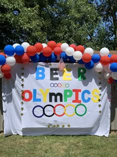 an olympic banner with balloons and streamers