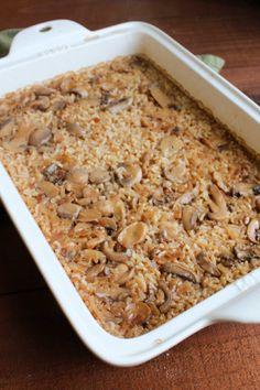 a casserole dish filled with rice and mushrooms