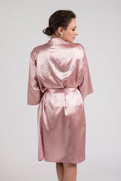 "This 3-pieces set is cut from blush pink soft satin in a kimono-inspired silhouette. It consists of the robe, camisole and shorts. It has a relaxed fit and detachable sash belt to keep it secure. Premium glass rhinestones embellish robe's back with the sparkly graphic \"BRIDE\". Excellent to be worn on the morning of the wedding or the night before your special day. Everyone will love this gorgeous loungewear set and you will look stunning in your getting ready photographs. It is available in S Pink Satin Finish Robe For Wedding, Pink Satin Sets For Wedding Night, Blush Gown For Weddings, Pink Satin Gown For Wedding Night, Elegant Pink Bridesmaid Robe, Elegant Pink Wedding Robe, Wedding Night Pink Satin Gown, Pink Satin Robe With Satin Finish, Pink Gown For Wedding Night