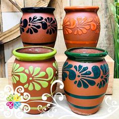 three vases sitting on top of a wooden table