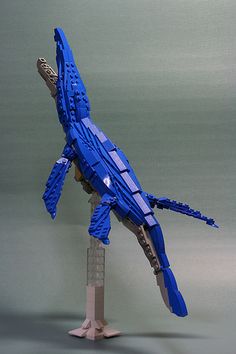 a lego model of a blue bird on a stand