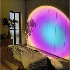 a room that has a large round light on the wall and a bed in front of it