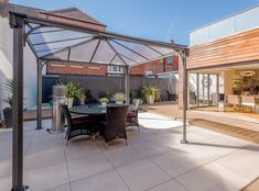 an outdoor dining area with table and chairs