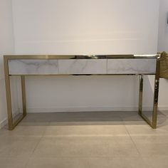 a white and gold console table in a room