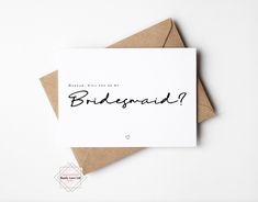 a card with the words bridesmaid written on it, next to an envelope