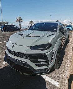 a silver sports car is parked on the side of the road