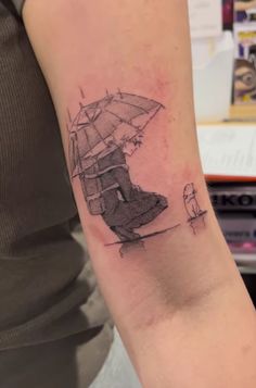 a person with a tattoo on their arm holding an umbrella