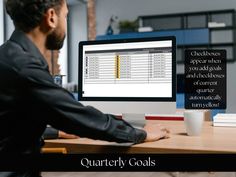 a man sitting at a desk in front of a computer with the words quality goals on it