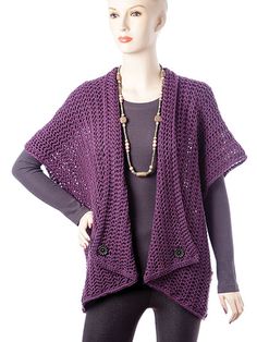 a mannequin wearing a purple sweater and black leggings with a necklace on it