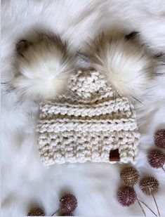 This is a super warm chunky knit hat made with 20% wool blend yarn. Ivory hat Topped with two removeable super soft and fluffy faux fur poms. Hat can be washed once poms are removed. Lay flat to dry. Poms can be fluffed up by using a hair dryer on high for a few seconds. Can be made in other color. Please message me! Cozy Cream Soft Knit Hat, Cozy White Hat, Winter Cream Crochet Hat With Soft Knit, Cream Crochet Winter Hat With Soft Knit, Cream Soft Knit Crochet Hat For Winter, Cozy White Crochet Hat For Cold Weather, Cozy White Crochet Hat For Fall, White Crochet Beanie Hat For Fall, White Crochet Beanie For Fall