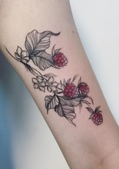 a woman's arm with flowers and leaves on it