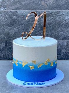 a blue and white cake with the number twenty on it