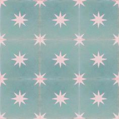 a blue and pink tile with white stars on it