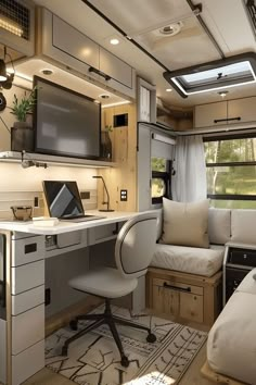 the interior of a camper with a desk, couch and television