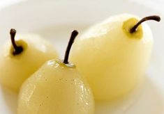 two pieces of fruit sitting on top of a white plate next to eachother