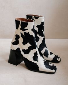 Get the quintessential 90s look with the wide block heel on this slim ankle boot. Zips along the side to elongate the legs and create a flattering silhouette. Available as a wardrobe basic in bicolor for a daring add to any fall winter look. Print Boots, Dr Shoes, Shoe Inspo, Aesthetic Shoes, Fur Boots, Dream Shoes, Mode Vintage, Mode Inspiration, Cow Print