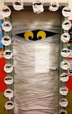 a room decorated with toilet paper and some sort of monster face in the middle of it