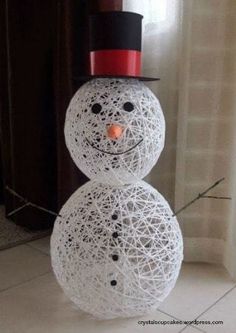 a snowman made out of yarn with a top hat