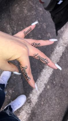 two fingers with words written on them