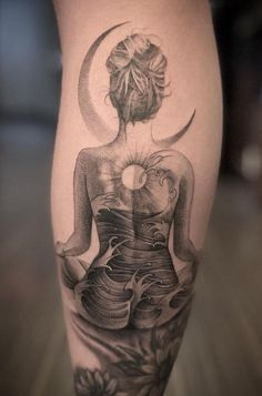 a woman with a tattoo on her leg is sitting in front of the sun and moon