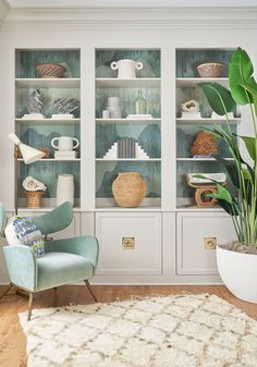 a living room filled with furniture and a potted plant