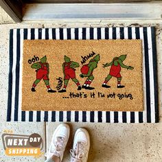 a door mat with three cartoon characters on it next to a pair of white shoes