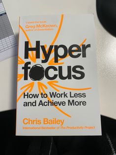 a book sitting on top of a desk next to a keyboard