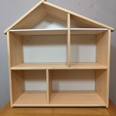 a doll house made out of wooden shelves