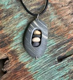 Beach stone with cairn stack of stones inside.  Beach stones found on the coast of Maine. Sterling silver jump ring is welded. Beach Stones Jewelry, Jewelry Beach, Beach Stones, Cairns, The Coast, Jump Rings, Stone Necklace, Stone Jewelry, Favorite Jewelry