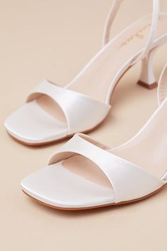 Whether you're the best-dressed guest or the bride-to-be, the Lulus Soline White Satin Slingback Low Heel Sandals are perfect for any special occasion! Sleek woven satin shapes these luxe heels that feature a trendy square footbed, a tapered toe strap, and a slender, adjustable slingback strap that secures with a gold buckle. A unique, sculpted heel completes the simple and sensational design. 2. 75" sculpted heel. Cushioned insole. Felted rubber sole has nonskid markings. Man made materials. Imported. Lulus | Soline White Satin Slingback Low Heel Sandal Heels | Size 5.5. Wedding Bride Shoes, Cheap Heels, Bridal Heels, Low Heel Sandals, Size 11 Heels, Sandal Heels, Bride Shoes, White Bridal, Heel Sandal