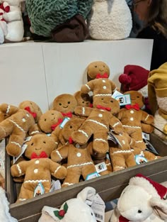 a crate filled with lots of different types of gingerbread men and women stuffed animals