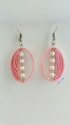 two pink hoops with pearls hanging from them