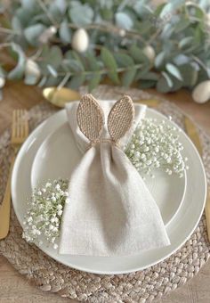 a white plate topped with a napkin covered in baby's breath