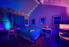 a bed room with a neatly made bed next to a computer desk and purple lighting