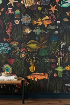 the wallpaper is very colorful and has many different types of fish, plants, and other things on it