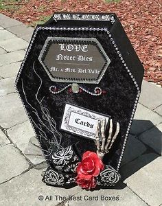 a black box with red roses and skeleton hands on the front sitting on a sidewalk