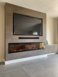 a flat screen tv mounted on the wall above a fireplace