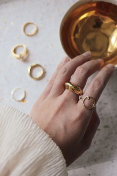 Paloma Gold Fill Dome Ring is a chunky gold ring that has a sculptural round shape. Minimal and elegant. This ring has a weight to it. Silver version: https://etsy.me/3aksajx ◊ 18K Gold Filled ◊ 100% Nickel Free ◊ Delivered in our signature blue box from Seoul SAY HI TO US Instagram: @thepinablue Pinterest: https://www.pinterest.com/thepinablue Facebook: https://www.facebook.com/thepinablue/ #pinablue Gold Open Dome Ring In Recycled Gold, Gold Crystal Ring Tarnish Resistant, Gold Tarnish Resistant Crystal Ring, Modern Gold Thick Band Diamond Ring, Modern Gold Round Diamond Ring, Everyday Gold Plated Dome Ring, Gold Crystal Ring With Round Band For Everyday, Gold Open Crystal Ring With Polished Finish, Gold Crystal Open Ring With Polished Finish