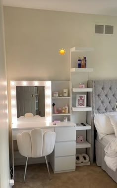 a bedroom with a bed, desk and mirror