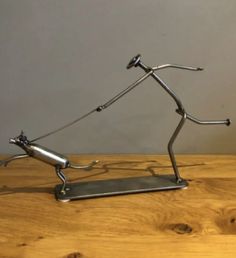 a metal sculpture sitting on top of a wooden table